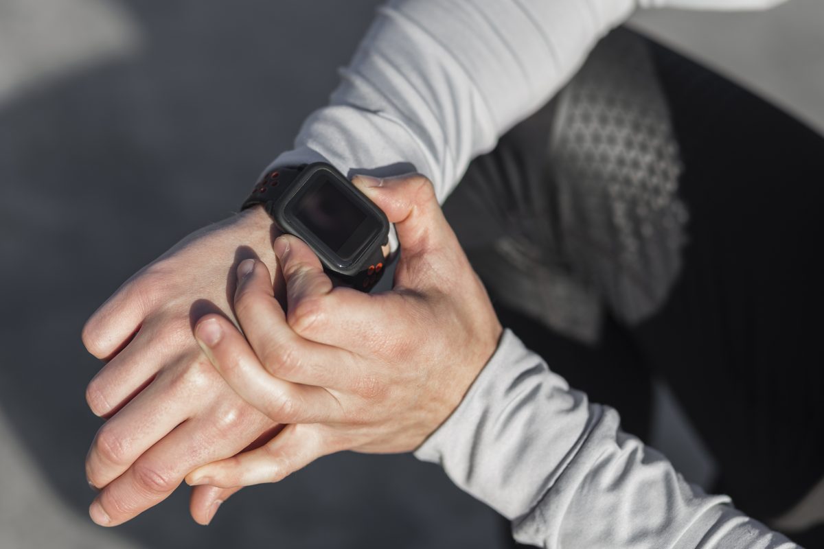 male hand adjusting sport watch